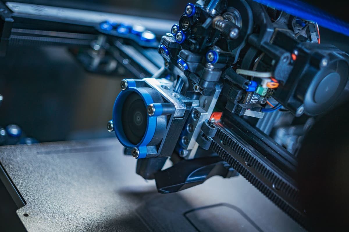 a metal printer frame with exposed wiring