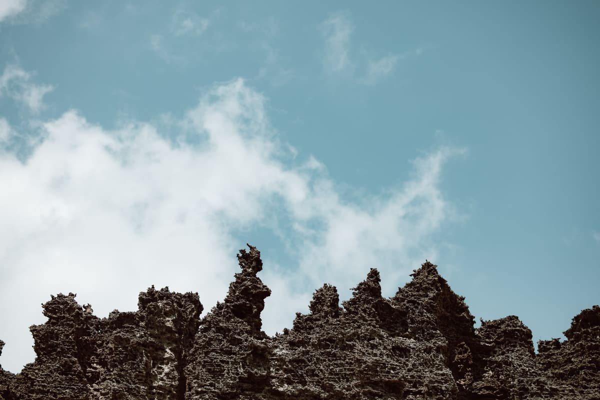 a dusty robotic arm hovering over a jagged crystalline rock