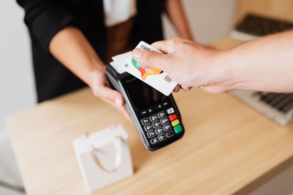a robot vacuum cleaner trying to use a credit card at a checkout counter