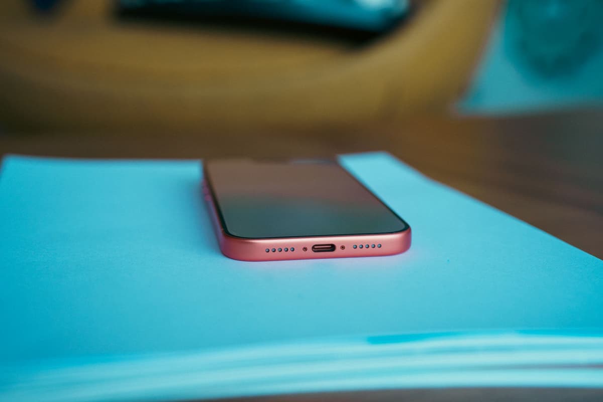 a row of dusty smartphones plugged into cheap USB hubs