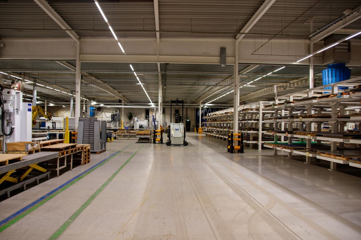 a single glowing server rack in a dark empty warehouse