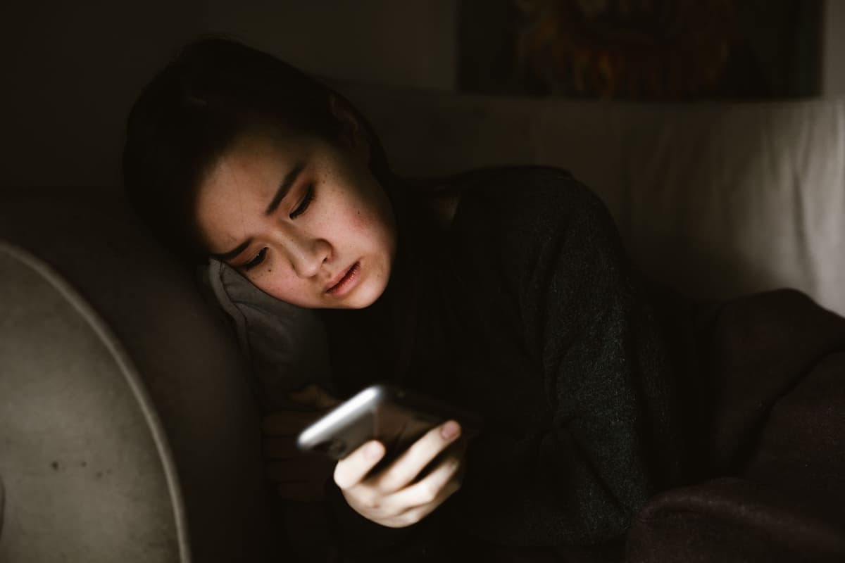 a person squinting at a distorted foldable phone screen