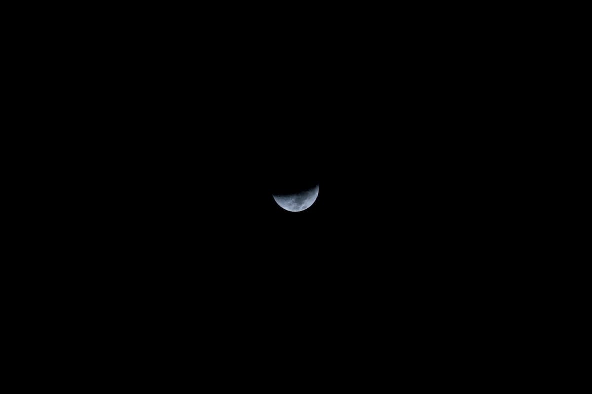 a lunar rover silhouette against a long jagged shadow