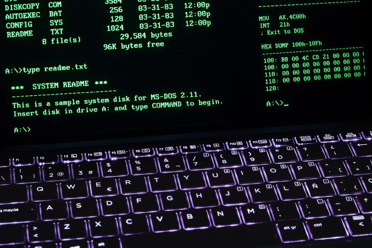 glowing computer monitor displaying dense terminal code