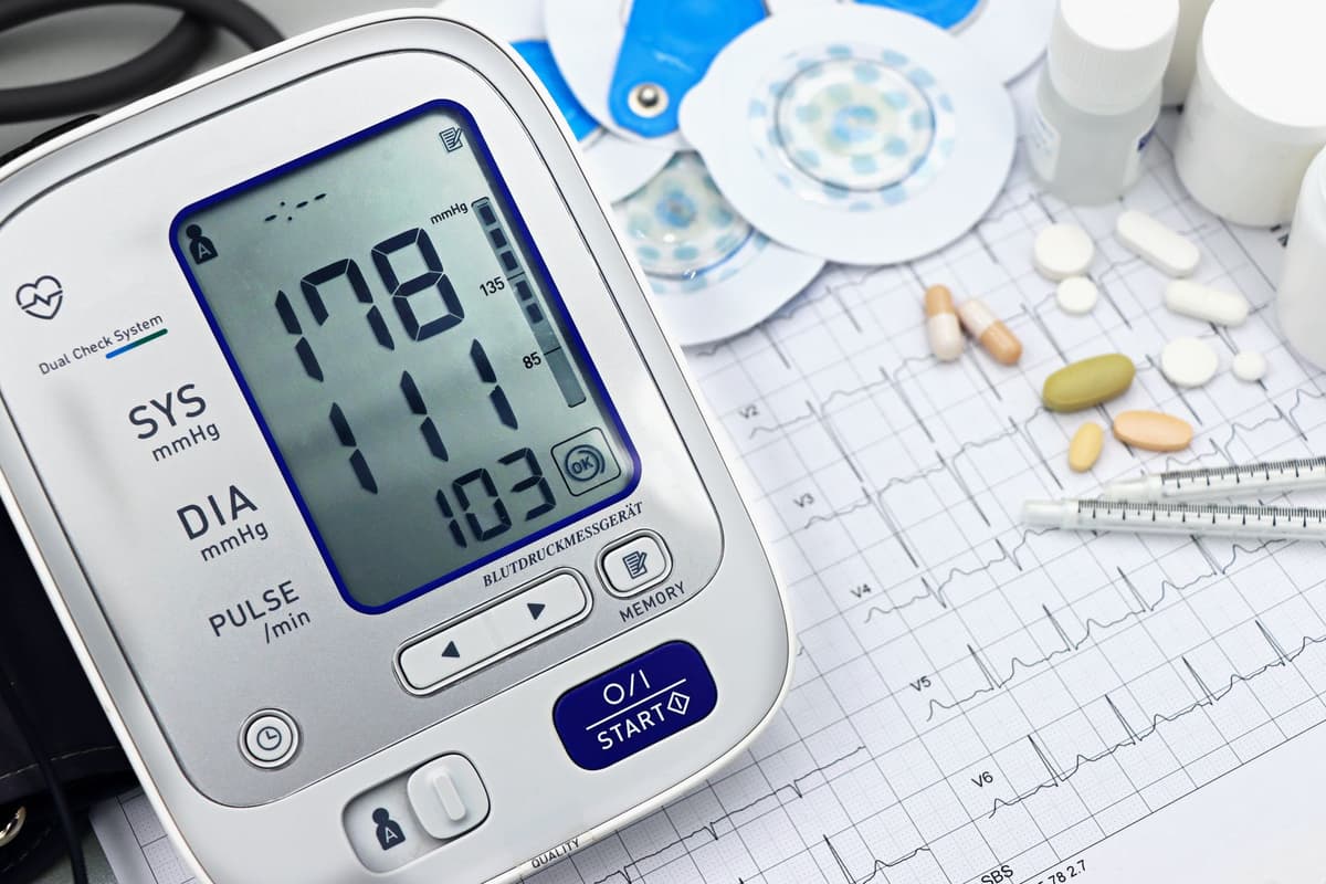 a sterile laboratory desk with a glowing blue tablet showing a flatlining heart rate monitor