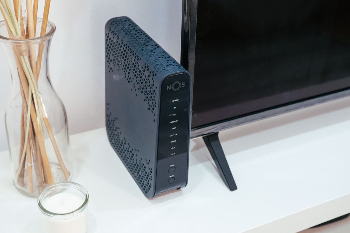 a dusty blue router sitting on a stained carpet