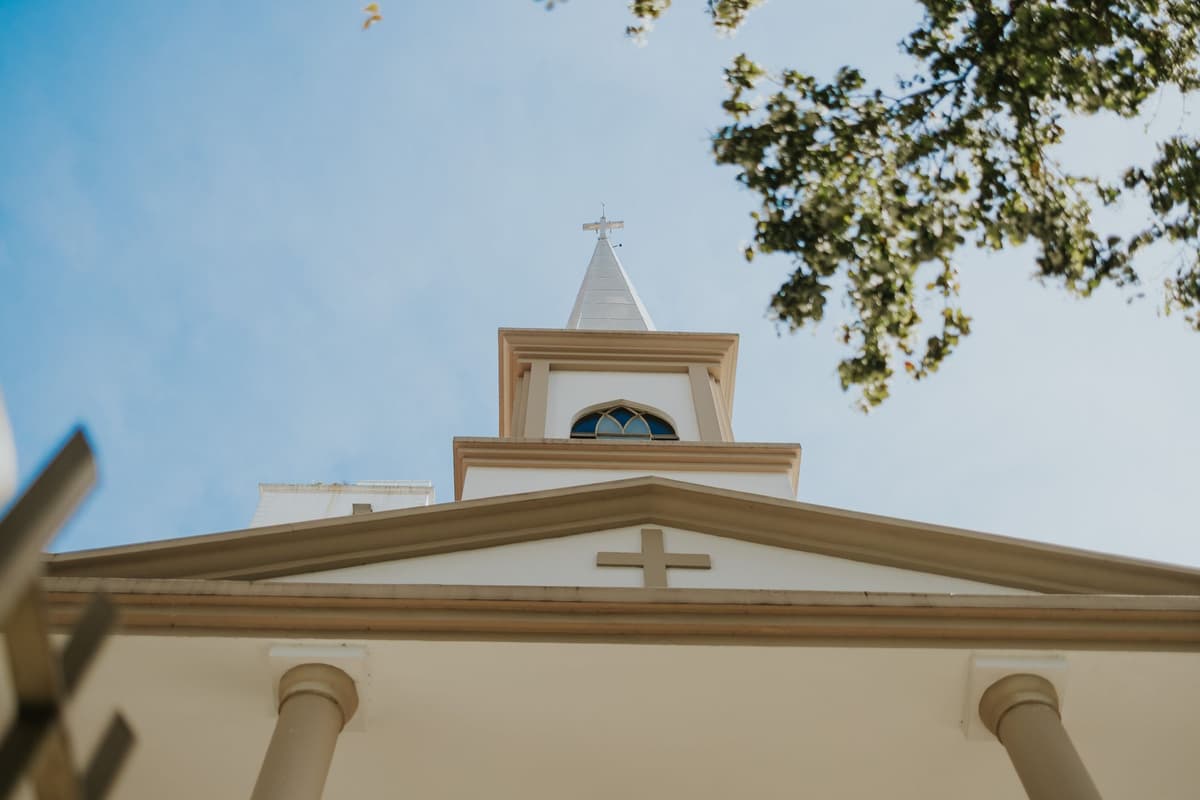 a single white church steeple rising from water