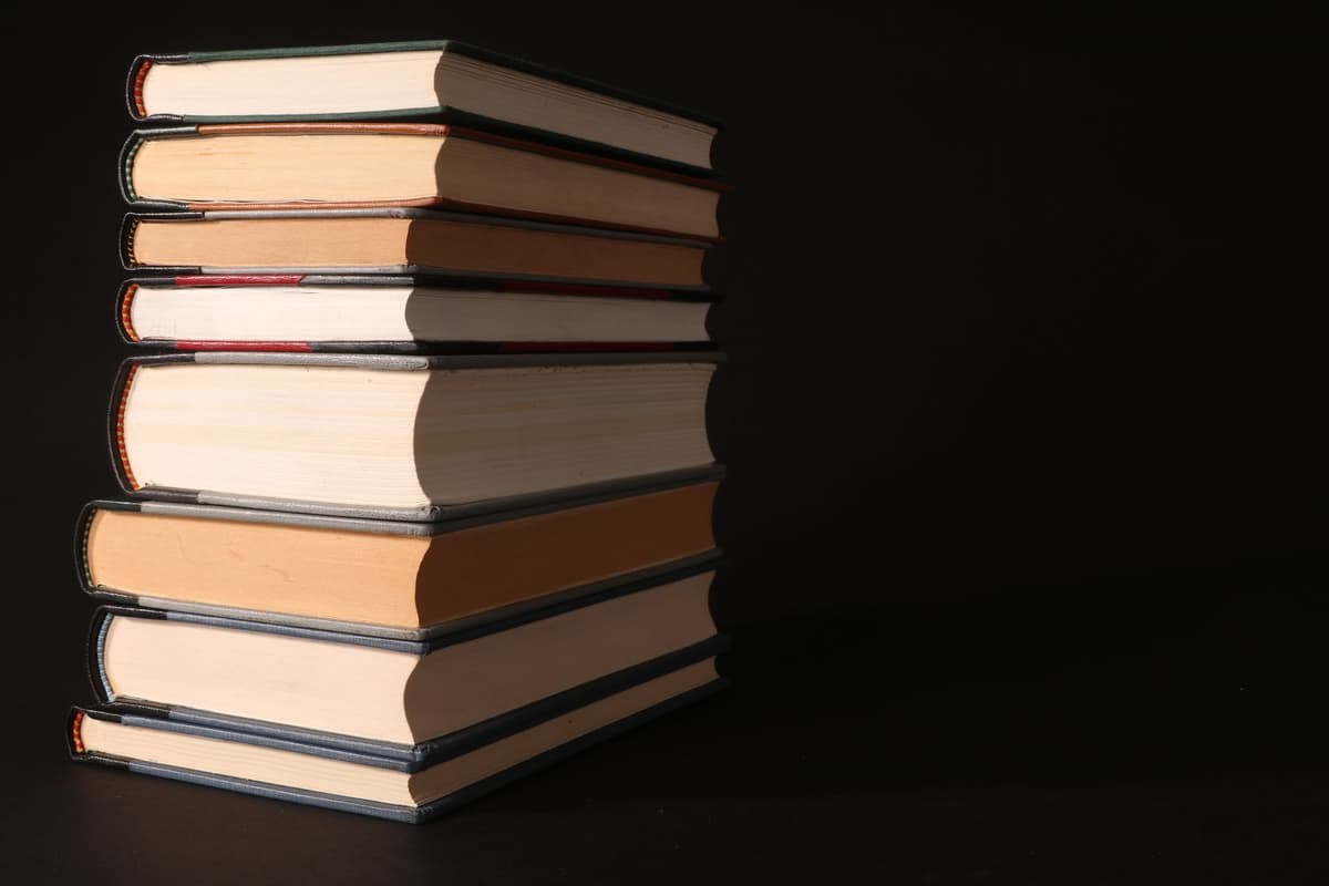 a thick book cut neatly in half with colorful duct tape on the edges