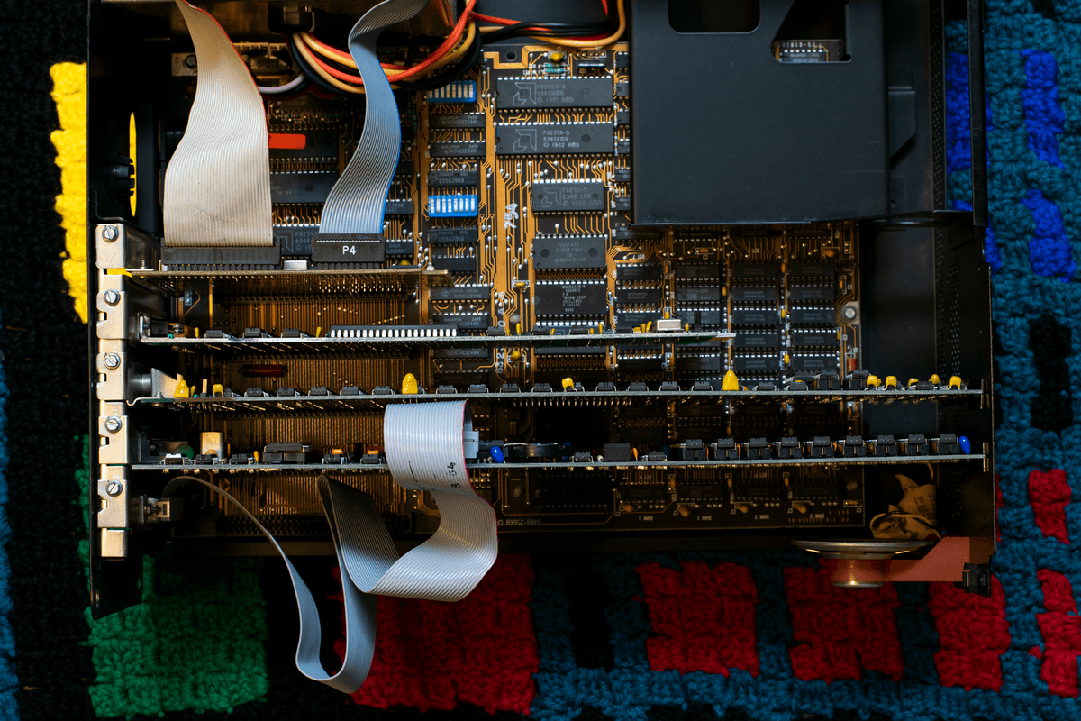 messy computer workbench with open circuits and cables