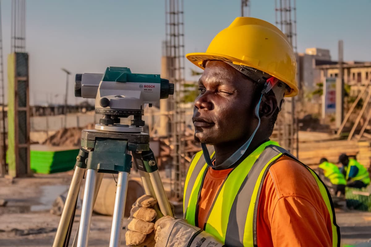 surveyor working with rugged tablet outdoors near dense forest
