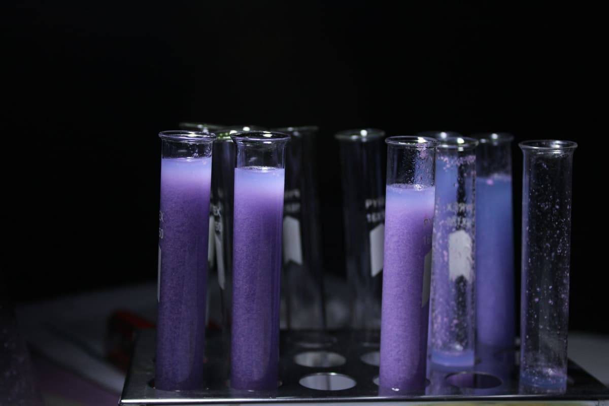 a single glowing test tube in a dark lab