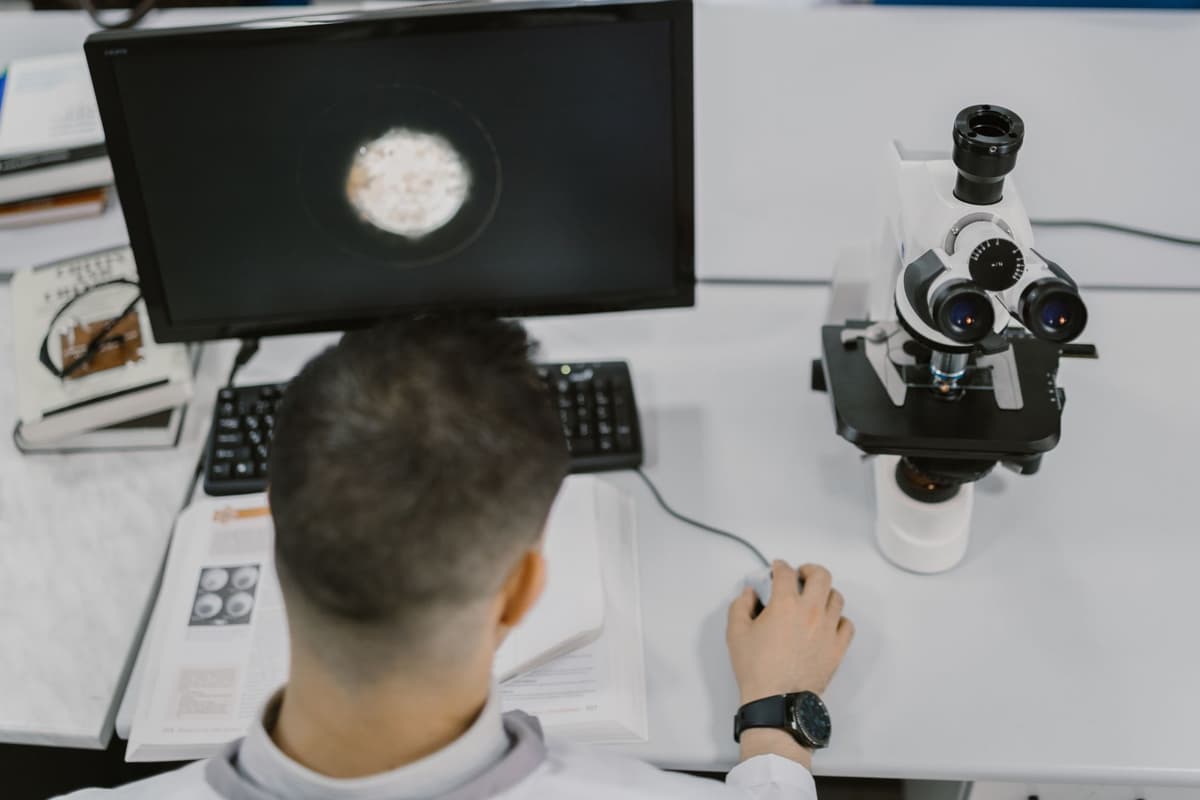 a man in a lab coat looking surprised at a spreadsheet