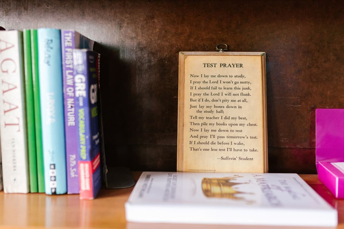 a minimalist wooden e-ink frame on a bookshelf