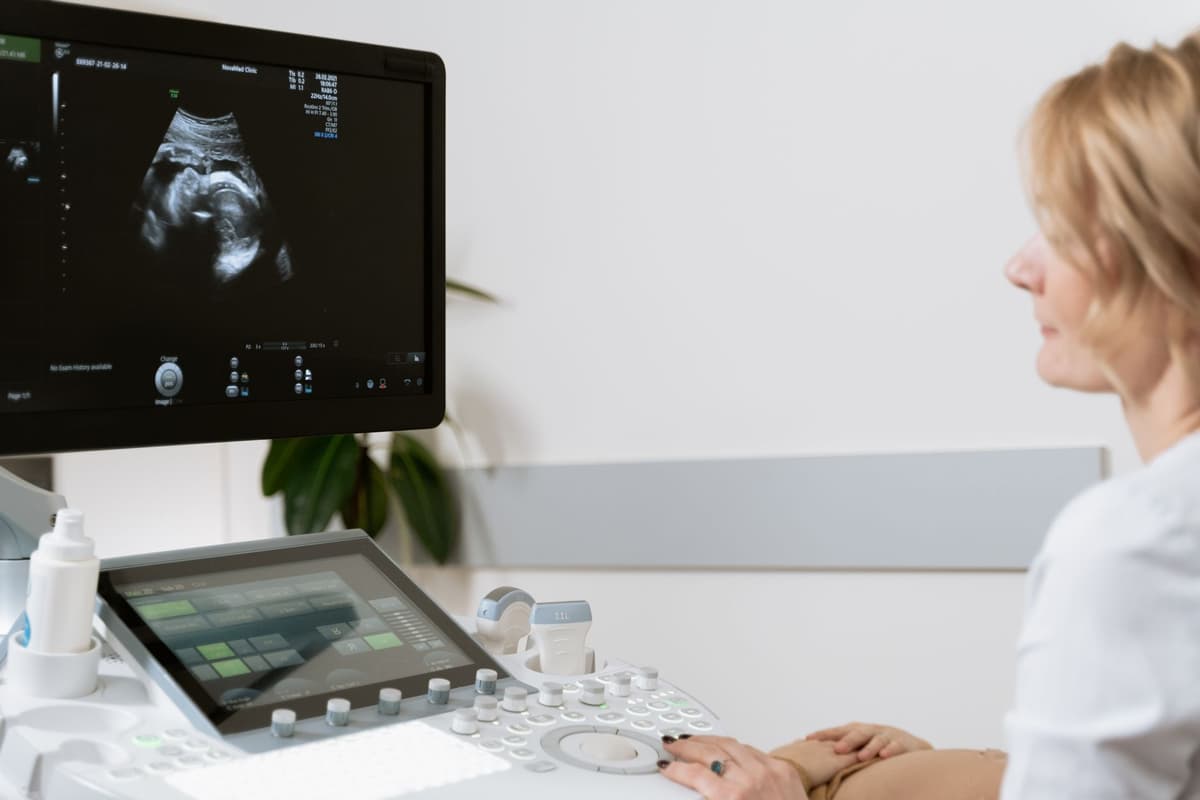 a surgical monitor displaying a clean anatomical scan next to a flickering glitchy screen
