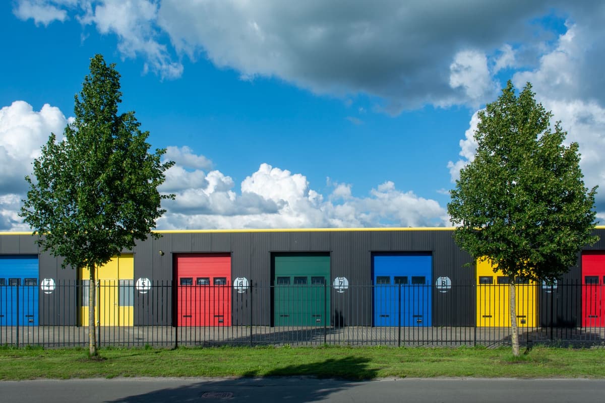 a long row of identical orange storage unit doors