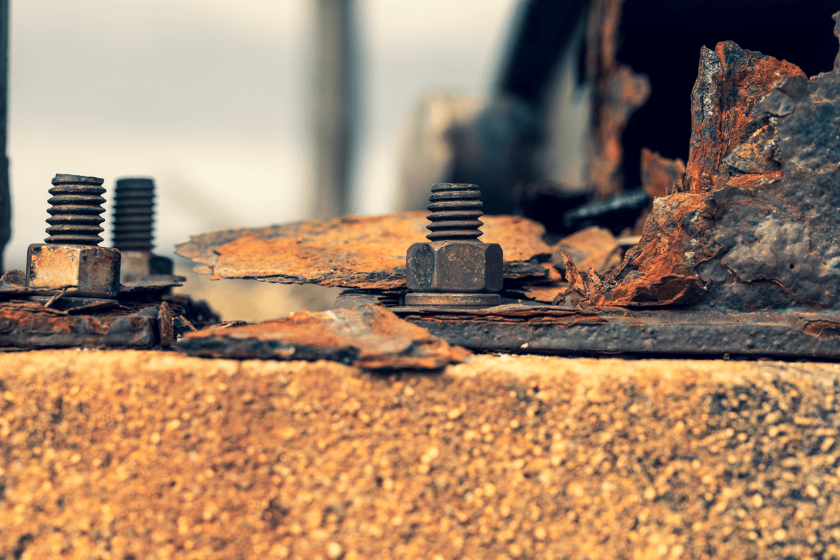 a single rusty bolt holding up a massive steel bridge