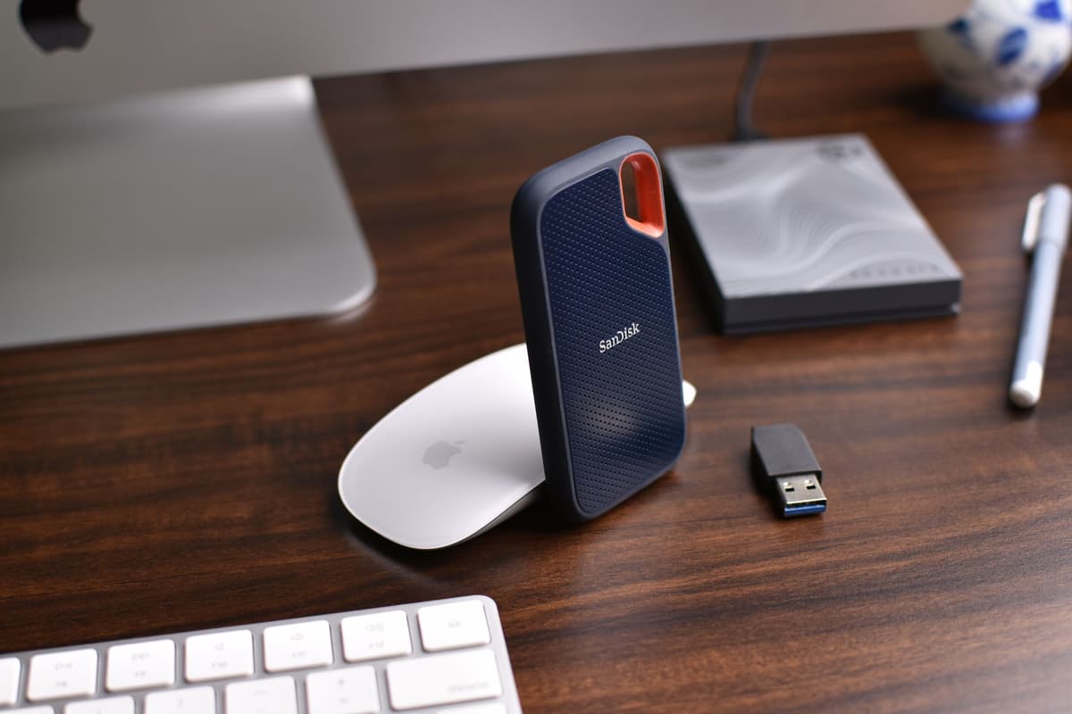 a dusty, oversized external hard drive plugged into a sleek laptop
