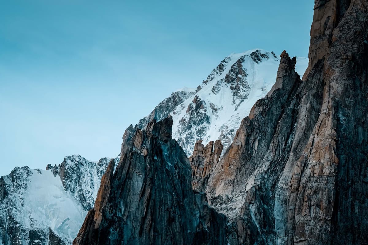 a jagged mountain peak with visible deep fissures and rockslides
