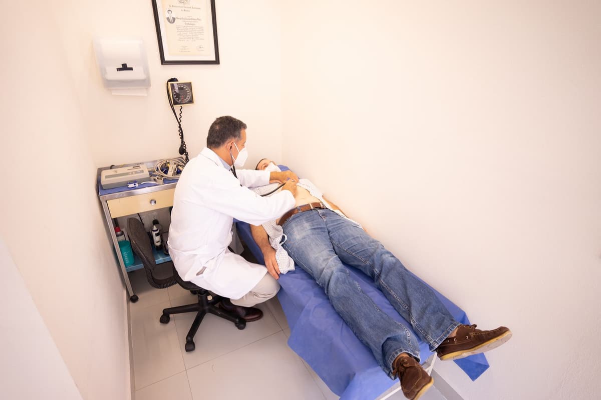 a doctor holding a massive industrial sledgehammer over a patient's chest