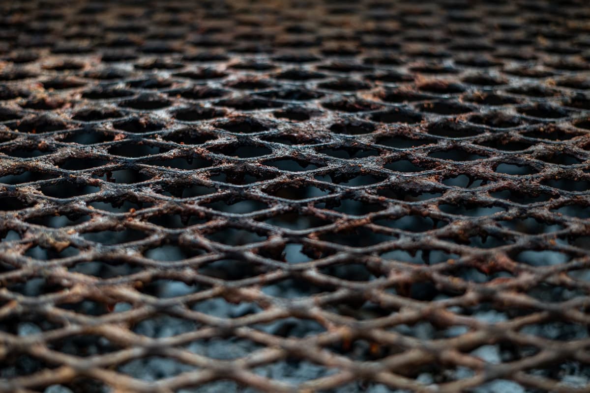 a heavy rusted iron hatchet resting on a lace doily