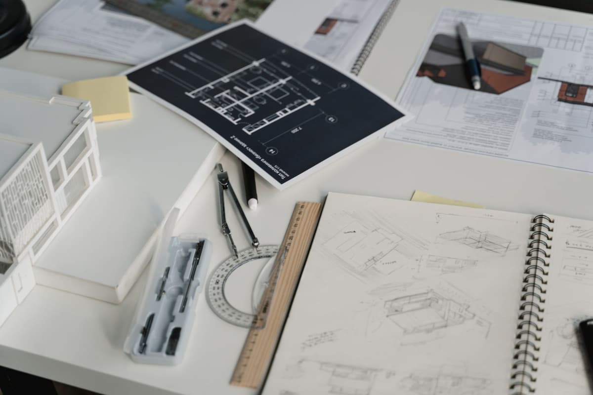 vintage electronic schematics and spiral bound manual on wooden desk