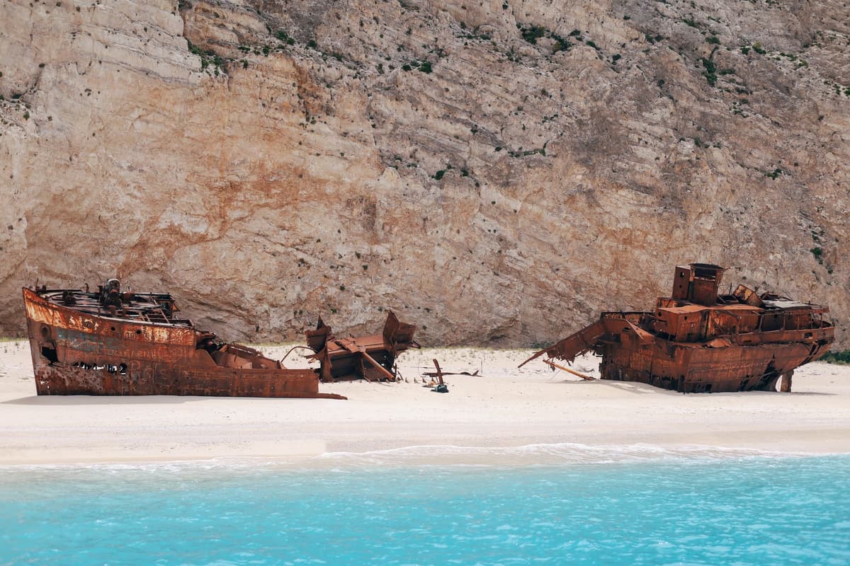 heavy rusted ship hull slicing through blue water