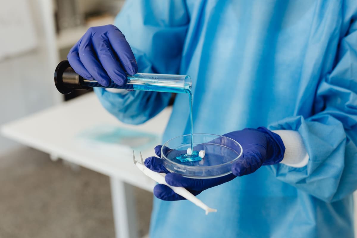 a technician injecting clear fluid into a transparent battery casing