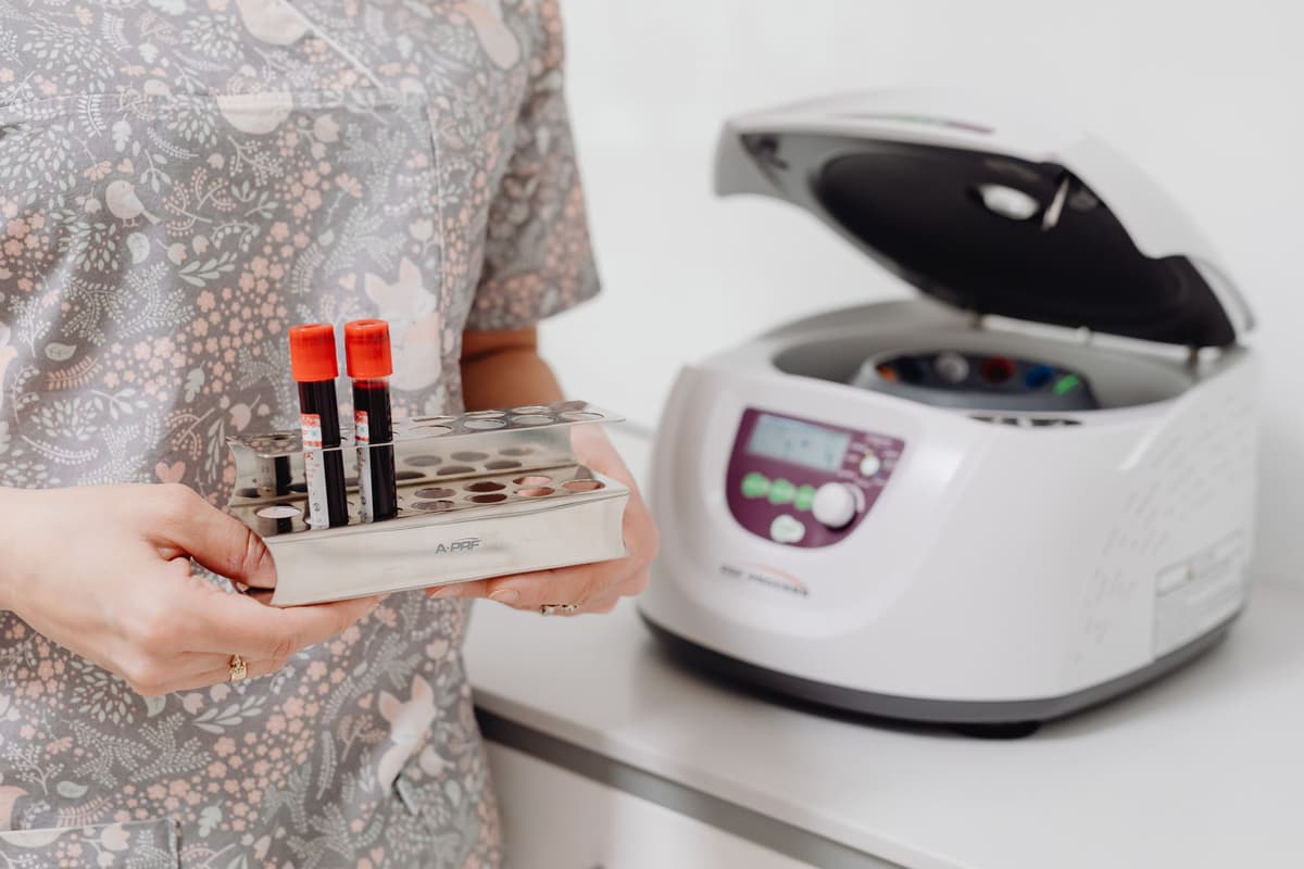 a researcher inspecting a tray of micro-centrifuge tubes