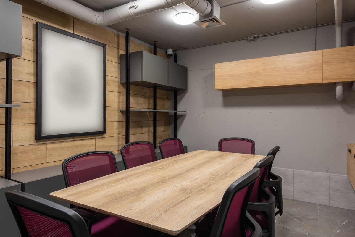 a small silver thumb drive sitting alone on a massive mahogany boardroom table