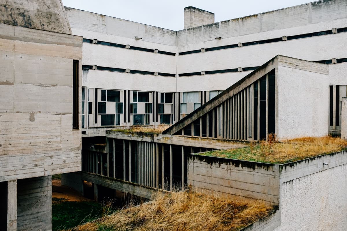brutalist concrete visitor center surrounded by pine trees