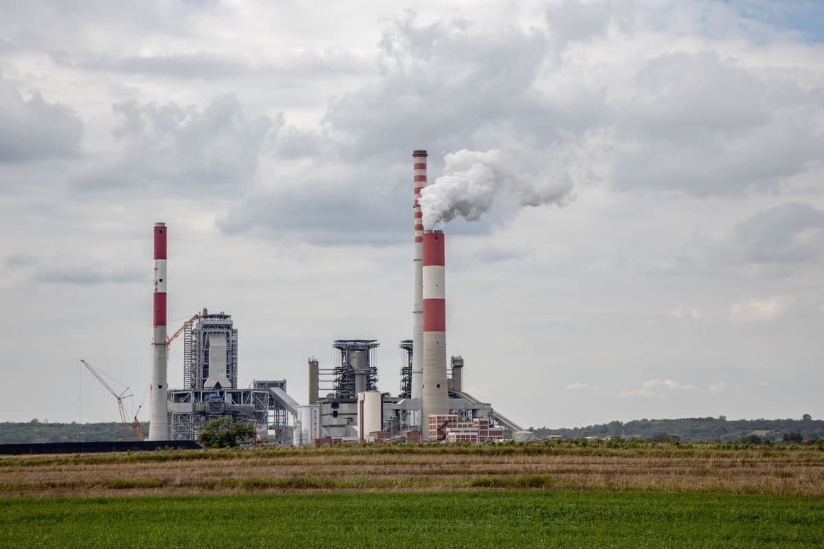 red brick power station chimneys against gray sky