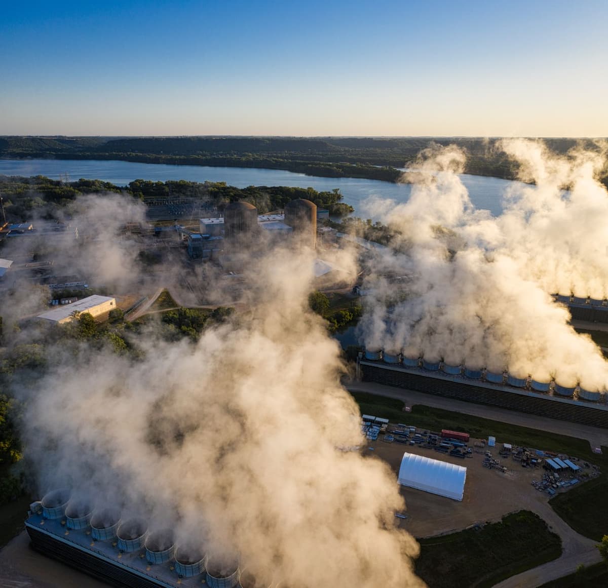 industrial cooling towers emitting thick white steam