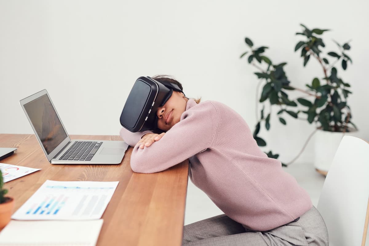 a single VR headset sitting on a cluttered wooden coffee table