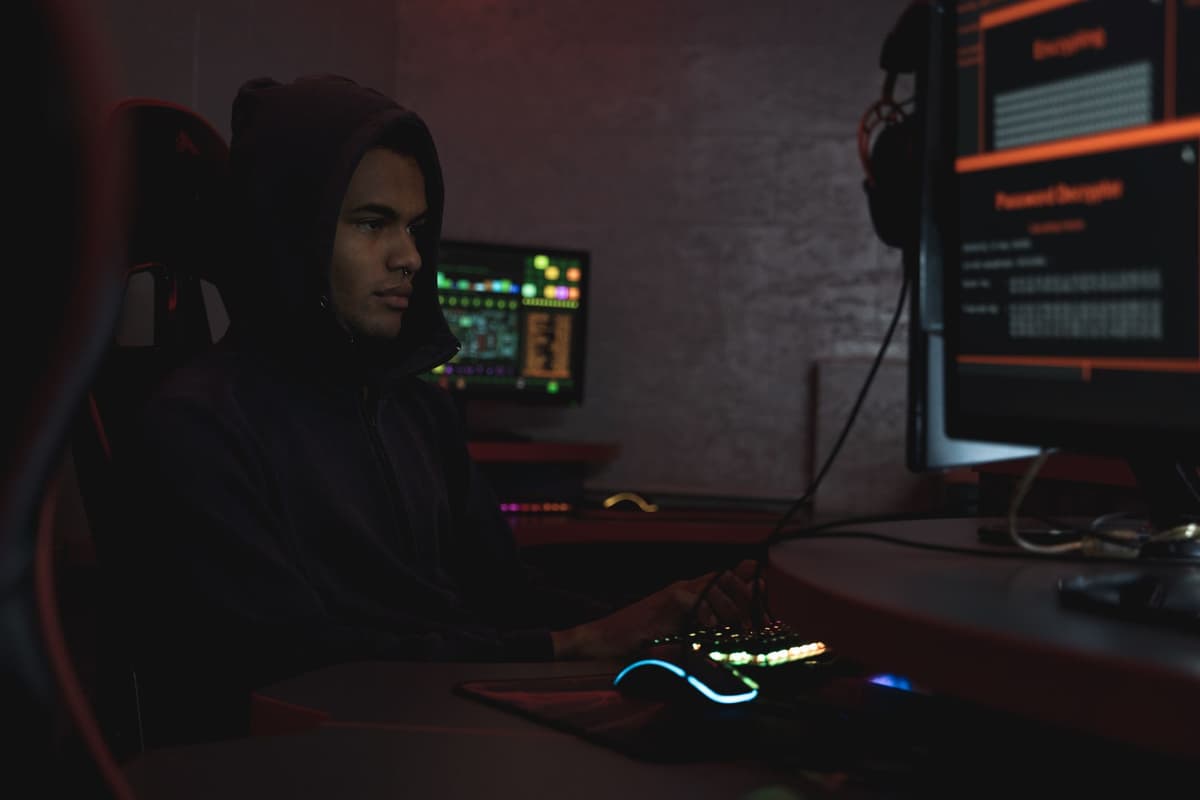 a technician staring at a glowing fridge screen in a dark kitchen
