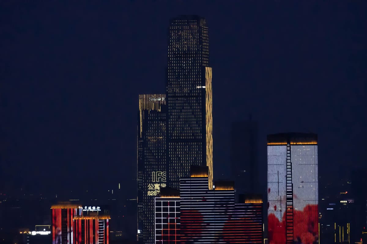 a futuristic city skyline with a massive loading bar projected on a building