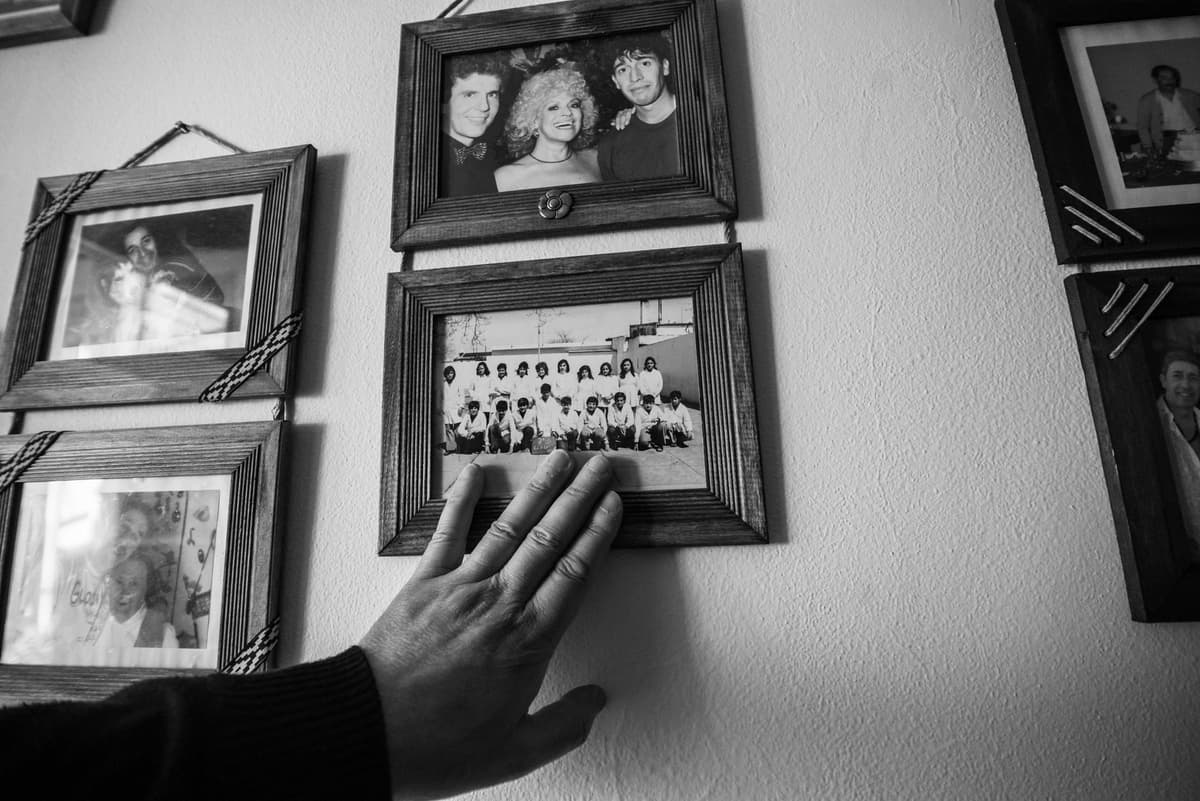 a dusty black and white Victorian photograph frame on a modern glass desk
