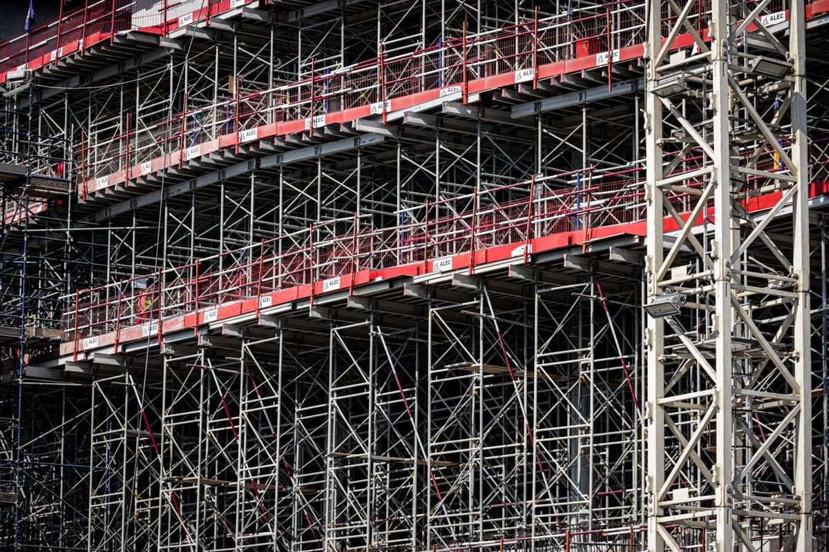 steel scaffolding and modular seating units being assembled