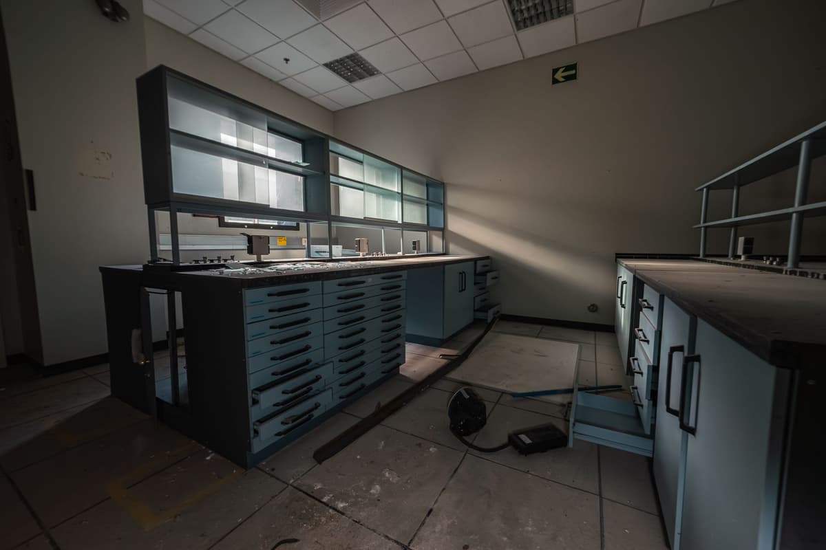 a dusty beige industrial computer tower in a dark corner