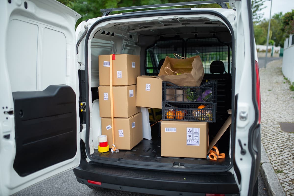 packed moving truck spilling cardboard boxes on street