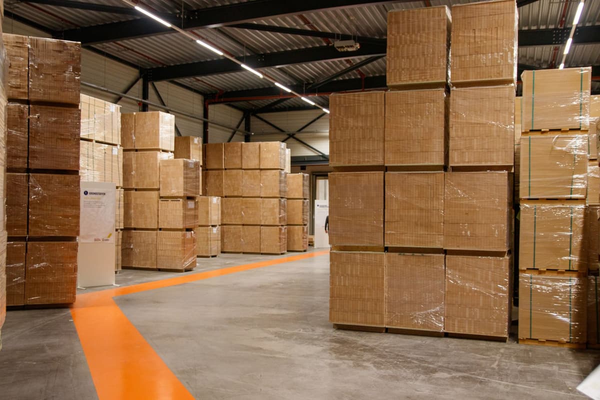 a single high-tech shipping crate in a vast empty warehouse