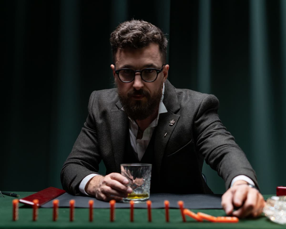 a man dramatically dropping a metal card onto a glass table