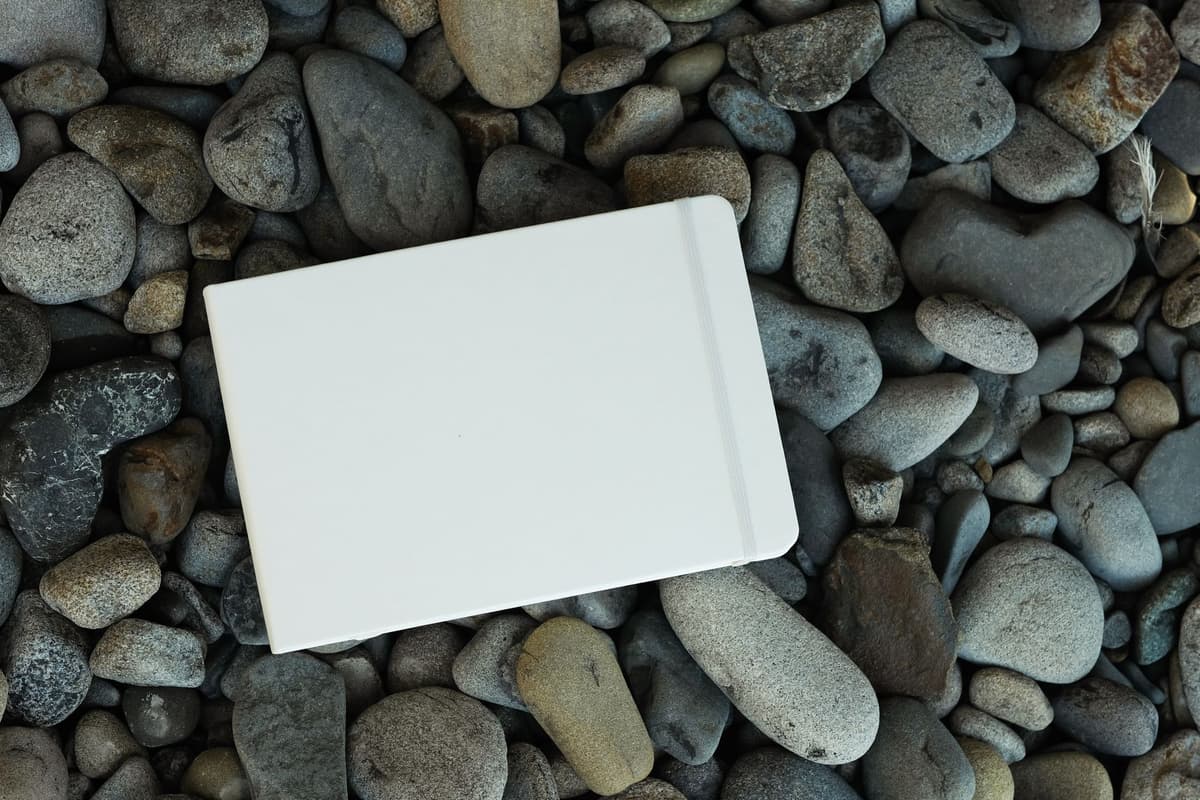 white plastic clipboard covered in gray moon dust