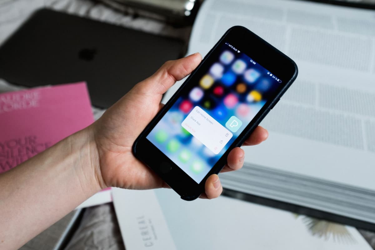 a person holding a smartphone with a locked padlock icon on the display