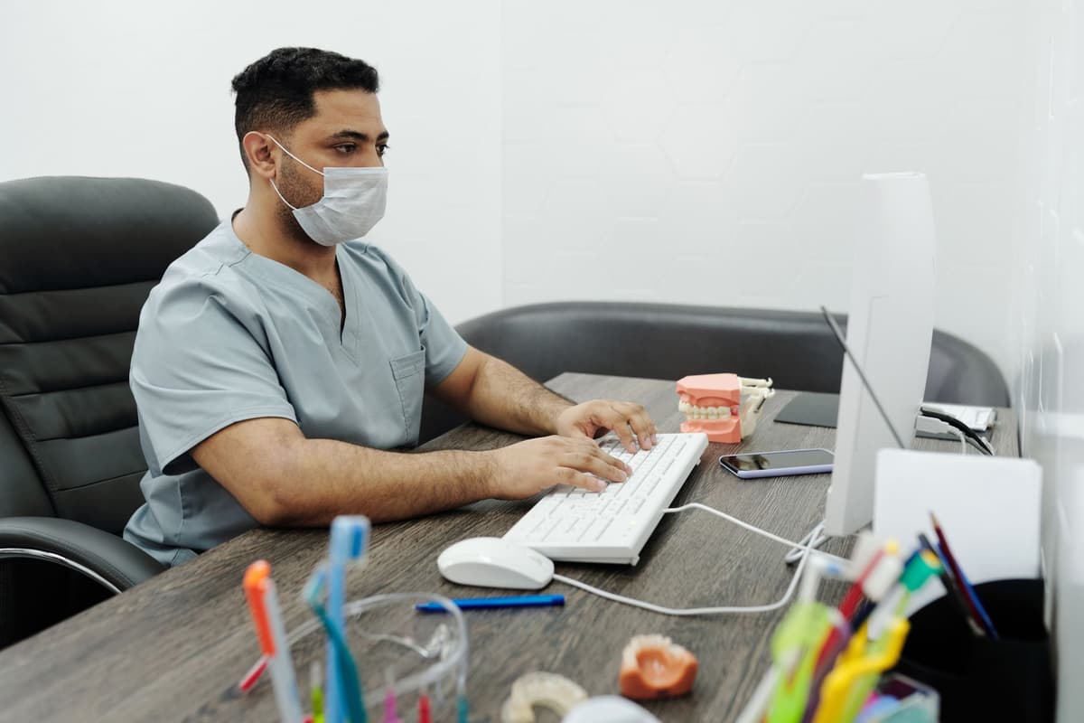 a doctor looking intensely at a computer monitor