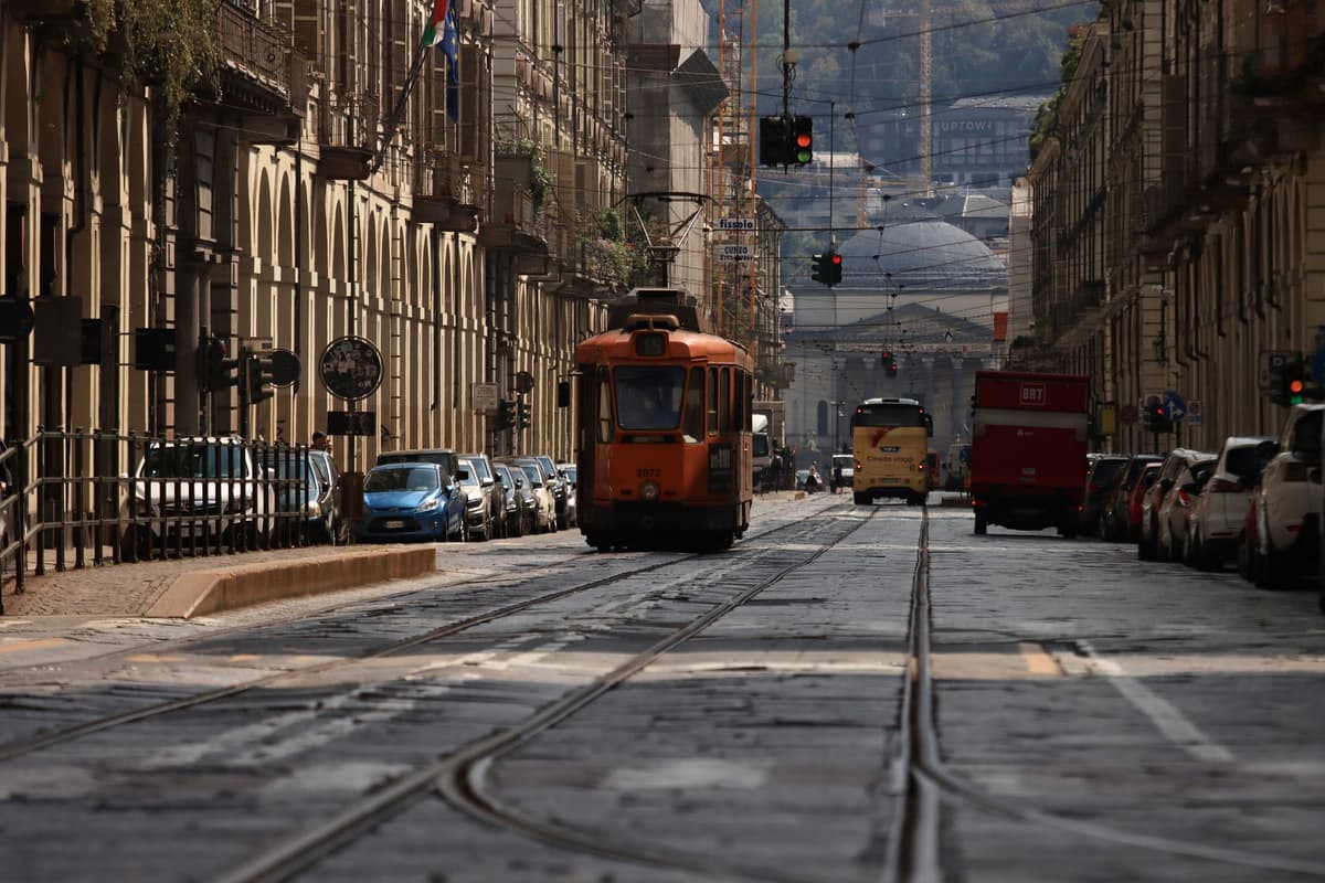 crowded historic city street with streetcars