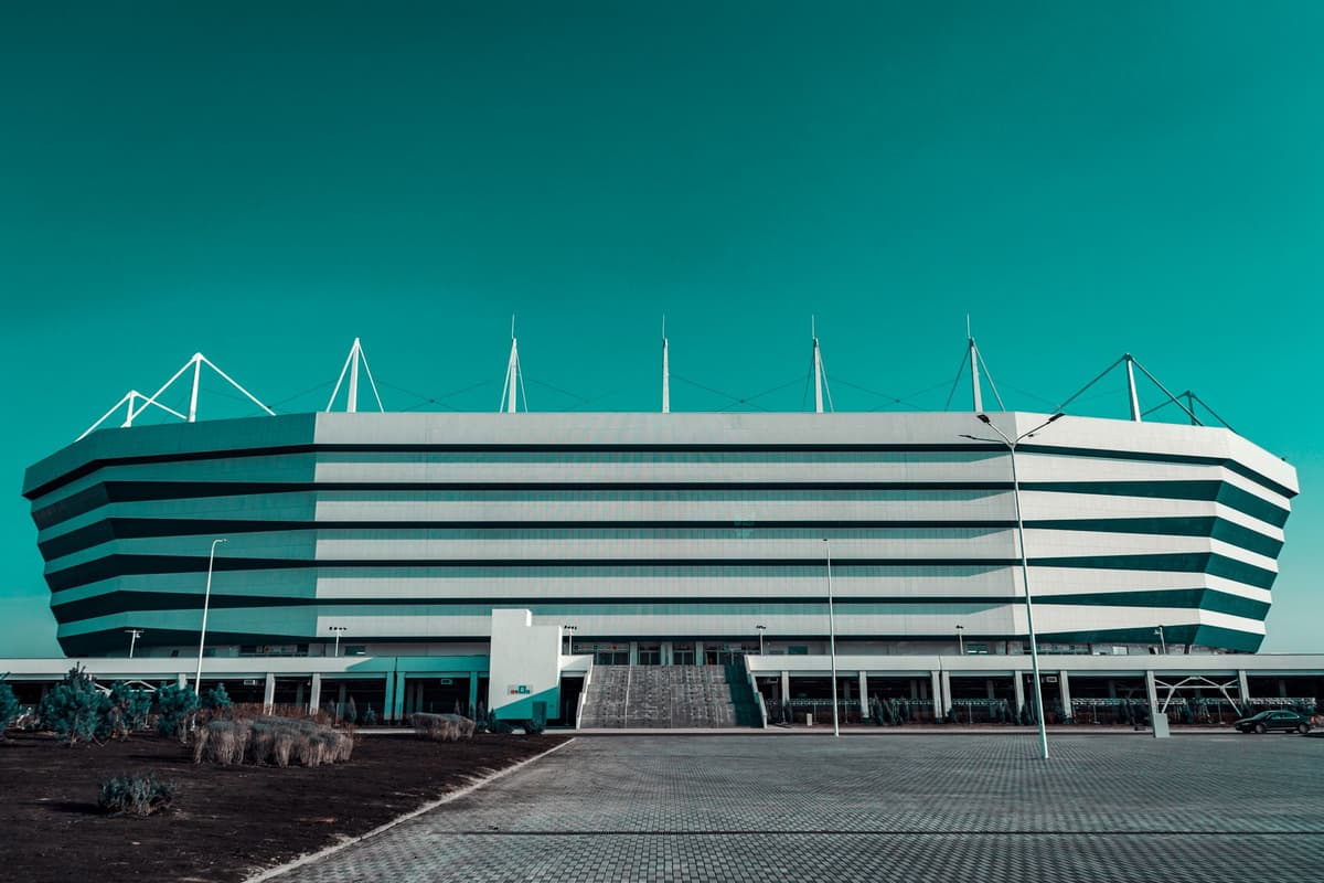 colorful, futuristic modular stadium structure being assembled