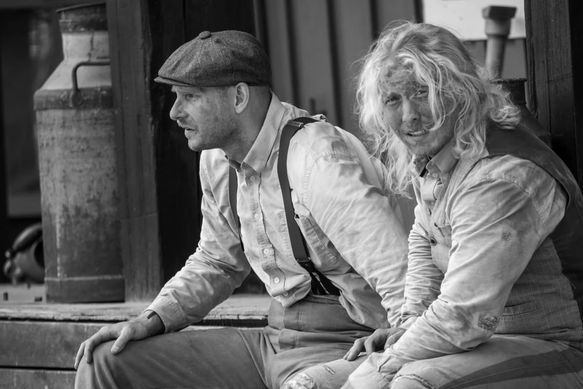 a dusty 19th century coal miner staring at an iPad