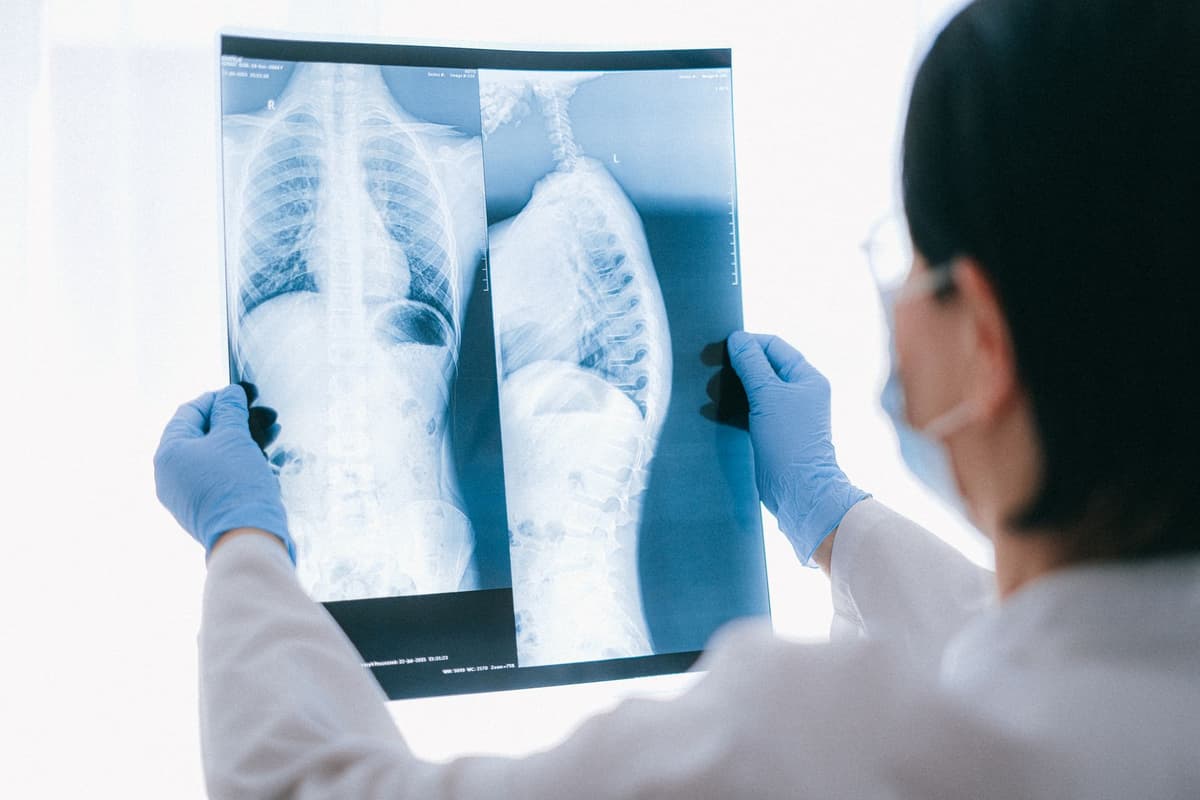 doctor staring at complex diagnostic screen in dark room
