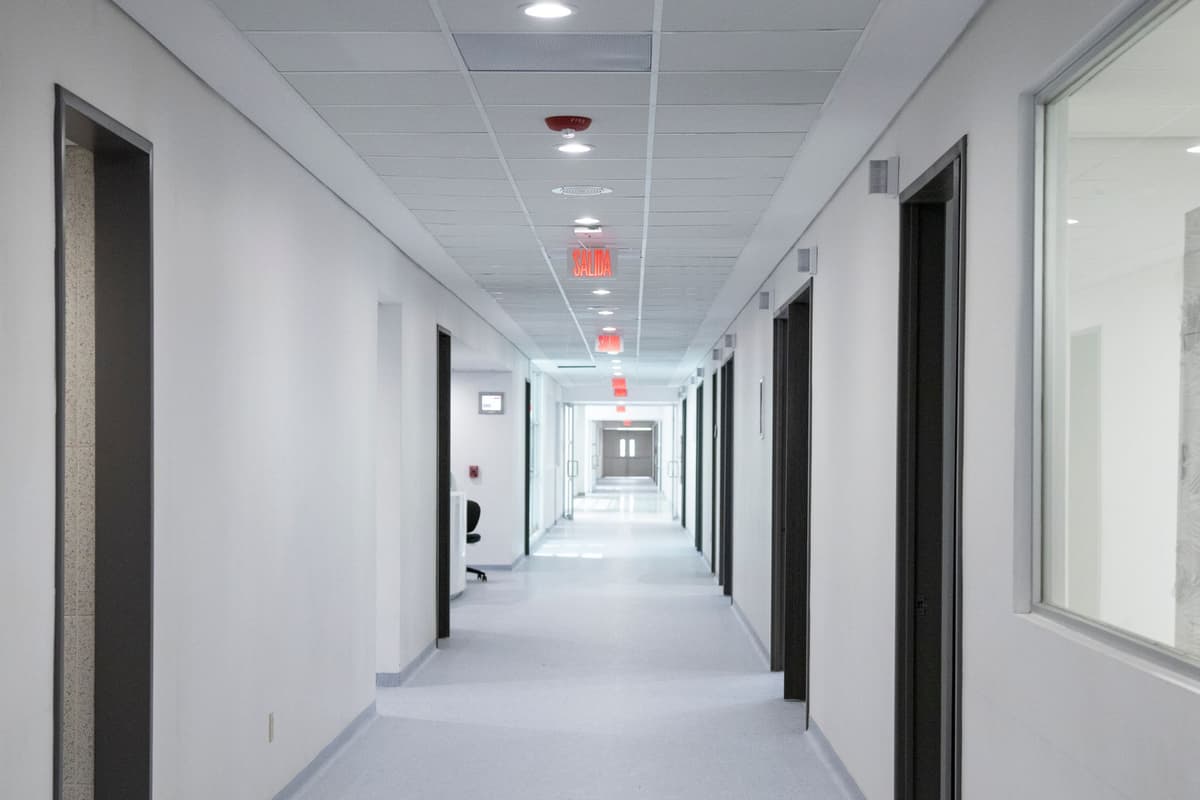 sterile hospital corridor with empty wheeled stretcher
