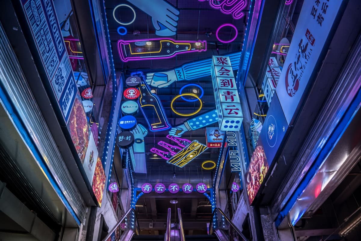 a dusty, empty library with glowing neon advertisements on every shelf